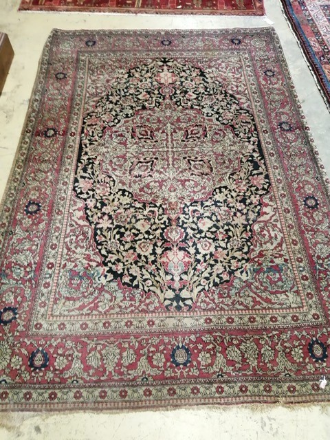 An Isphahan black ground rug with central foliate medallion, mulit-bordered, 202 x140cm